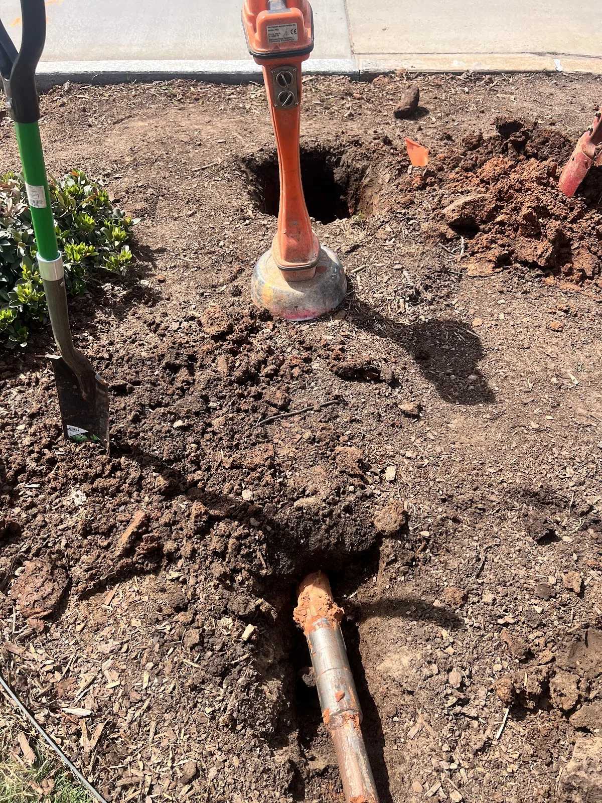 Worker Building Foundation Bore Dallas Texas HDD Contractors Texas HDD Contractors compact drill rig boring a new utility line across a residential front yard in Frisco Texas