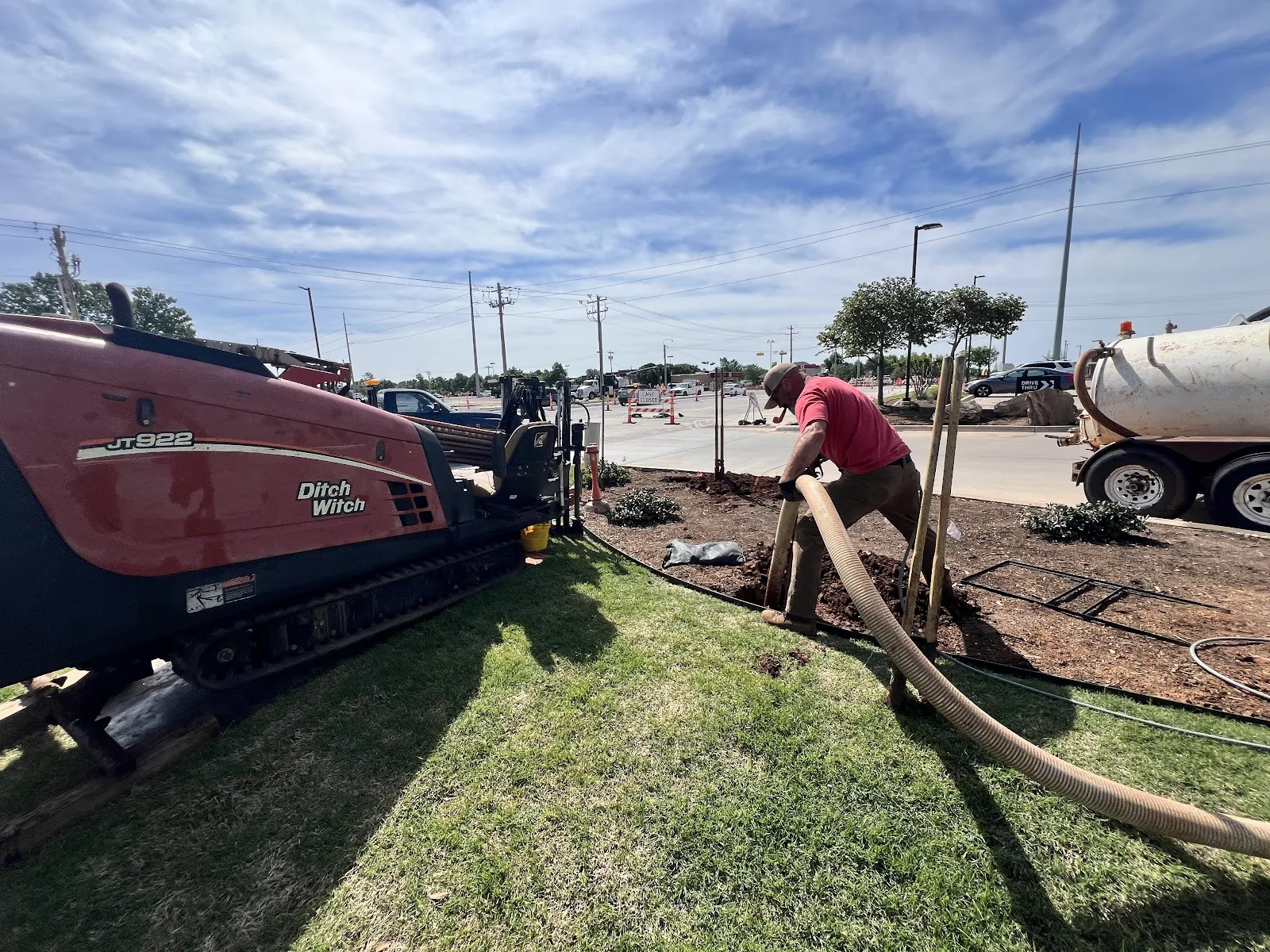 Reels of black HDPE fiber optic conduit on a Rotate-A-Reel trailer staged for trenchless directional boring fiber installation in Texas by Texas HDD Contractors