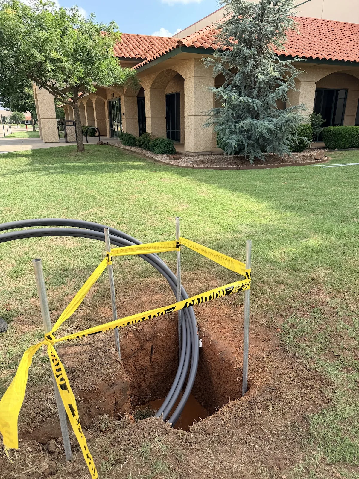 Potholing pit exposing a located utility line after a Texas 811 call in Frisco